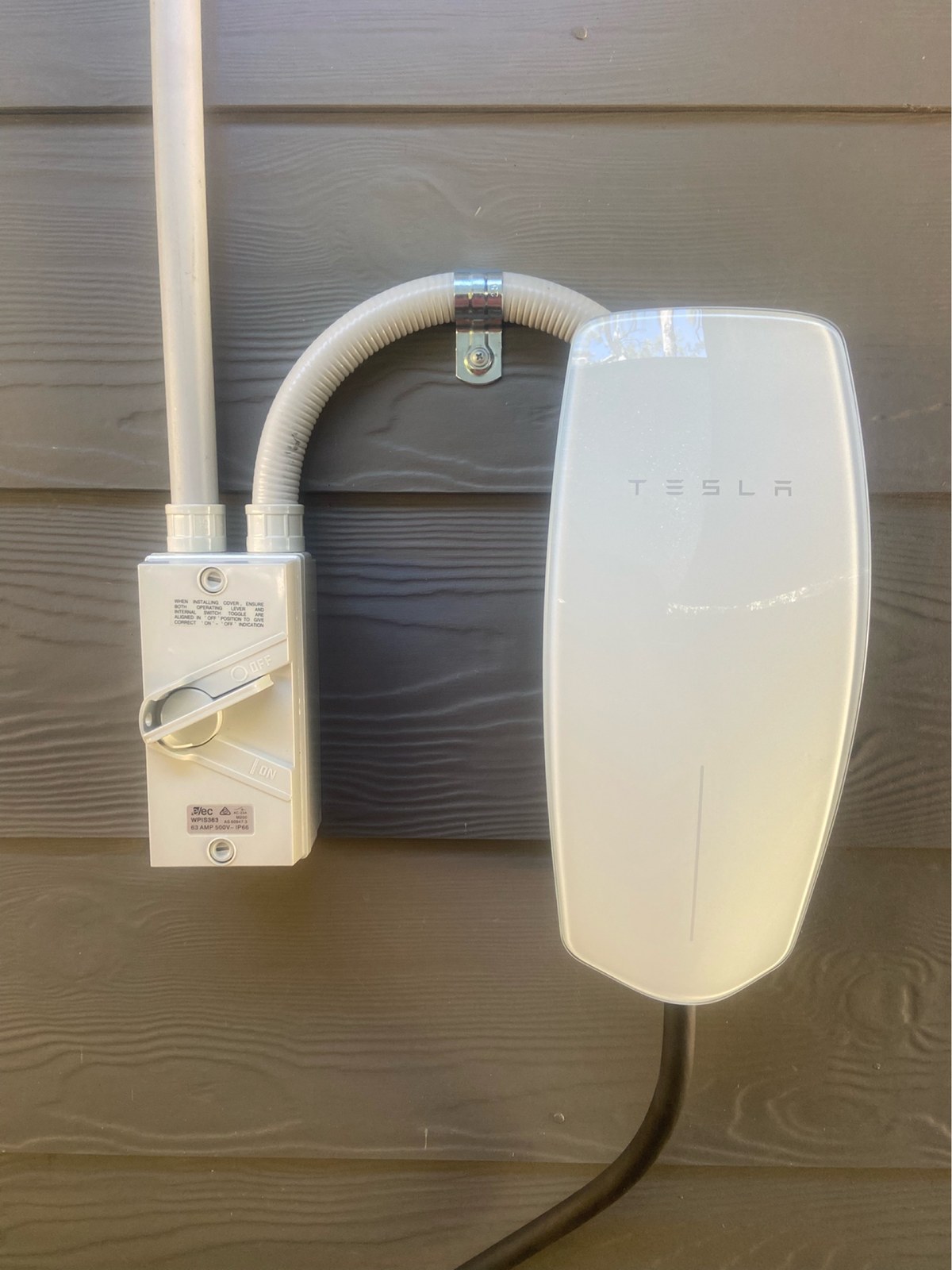 Wall mounted EV charger installed by Thorntek with a weatherproof isolator
