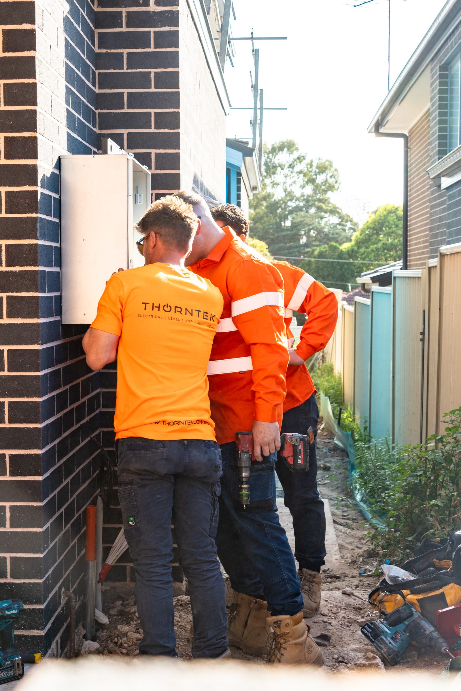 Thorntek crew wiring a meter box on site