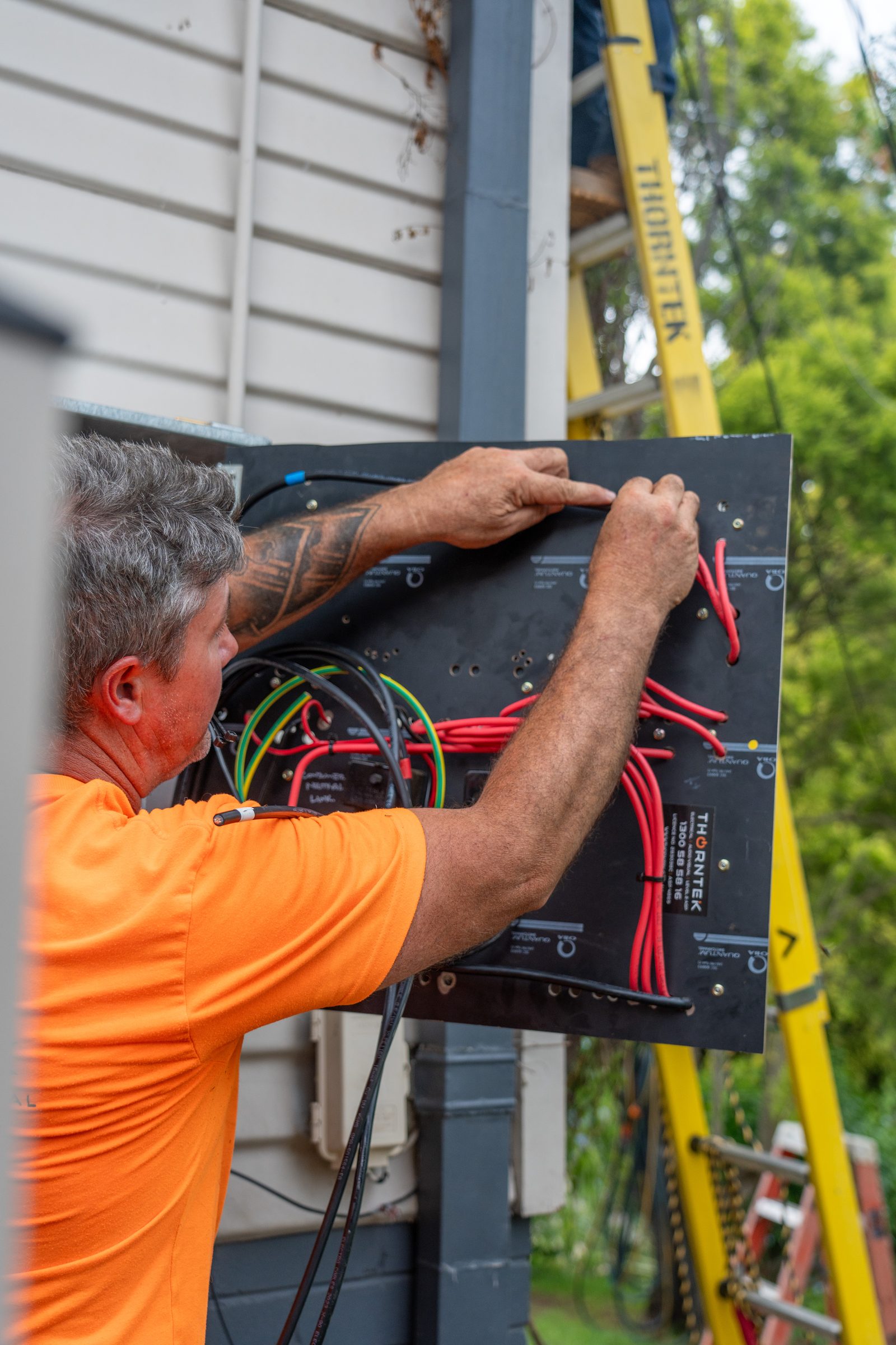 Thorntek electrician wiring the rear of a new meter panel during a switchboard upgrade